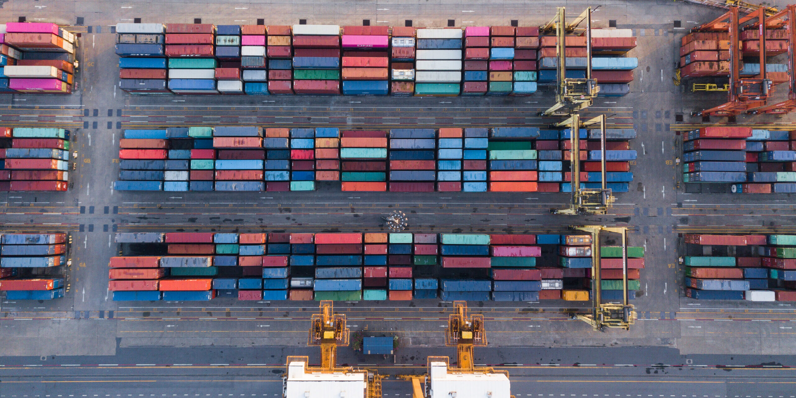 Aerial top view of container cargo ship in the export and import business and logistics international goods in urban city. Shipping cargo to the harbor by crane.